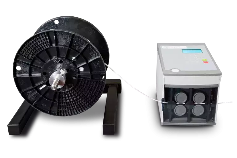 Two machines one is black and other is white and black machine is taking wire from white machine